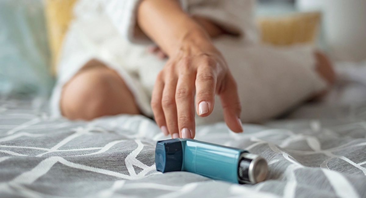 woman reaching for her inhaler