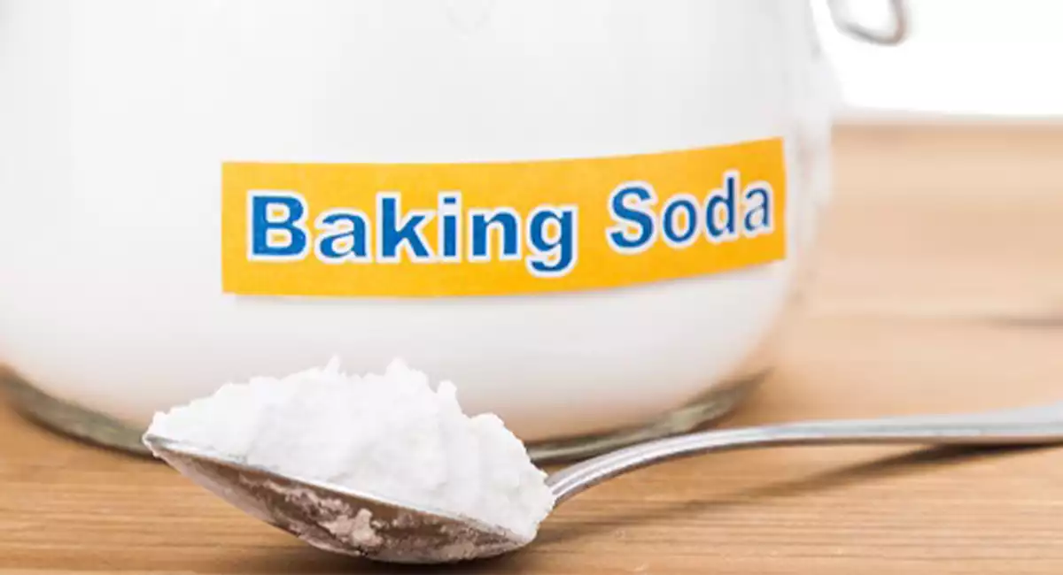 Jar with baking soda and spoon